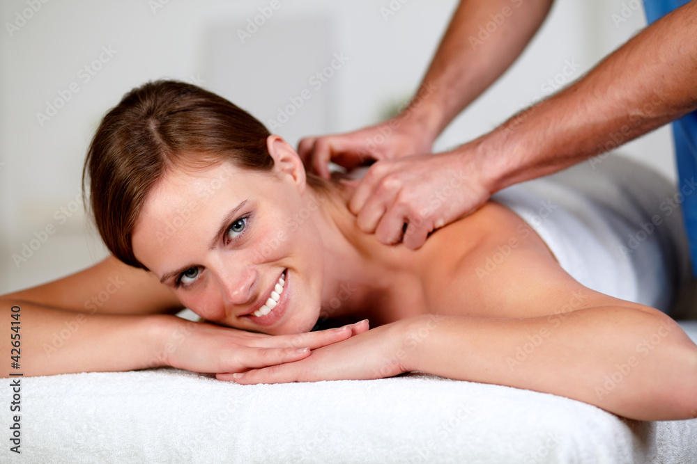 Young woman receiving a relaxed massage at a spa Young woman receiving a relaxed massage at a spa