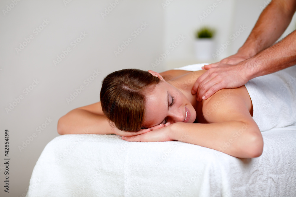 Young woman with eyes closed receiving a massage Young woman with eyes closed receiving a massage