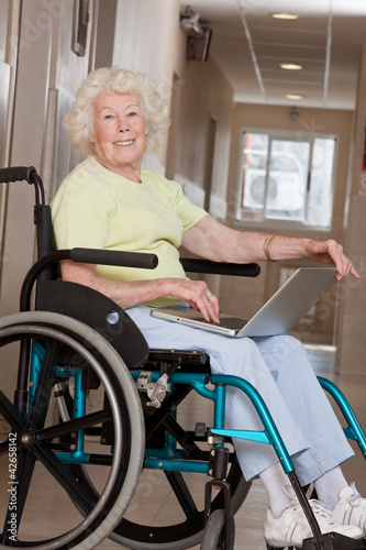 Woman on Wheelchair Using Laptop