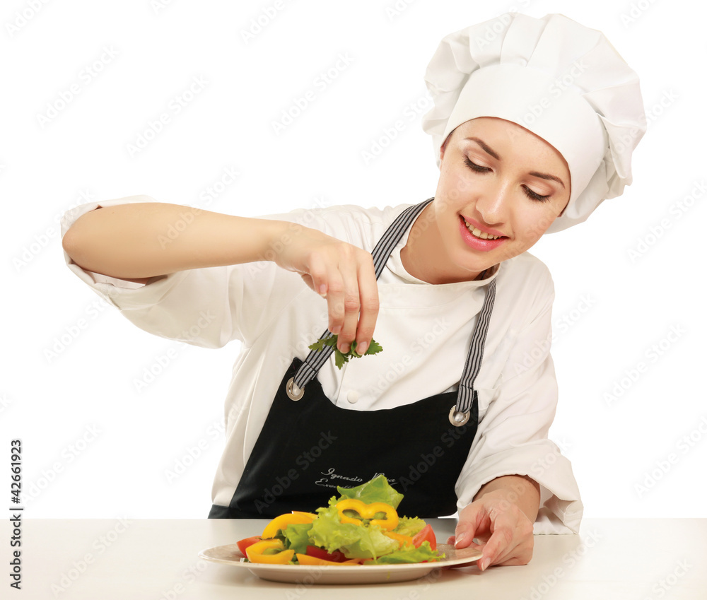 Portrait of a young cook in uniform preparing meal Portrait of a young cook in uniform preparing meal