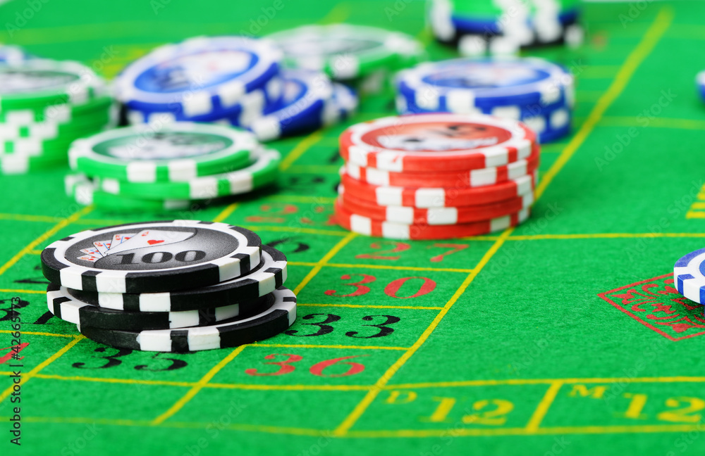 Gaming chips on the green cloth Gaming chips on the green cloth