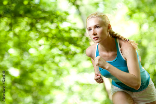 Woman Running Outdoors in Forest