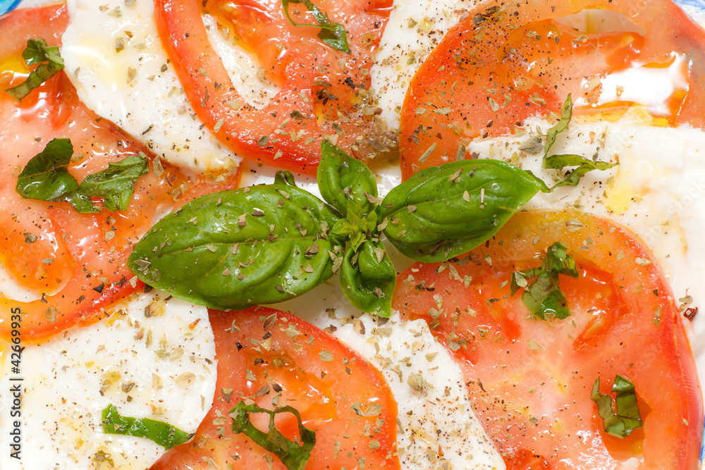 Caprese. Tomato and mozzarella salad with basil.. Caprese. Tomato and mozzarella salad with basil..