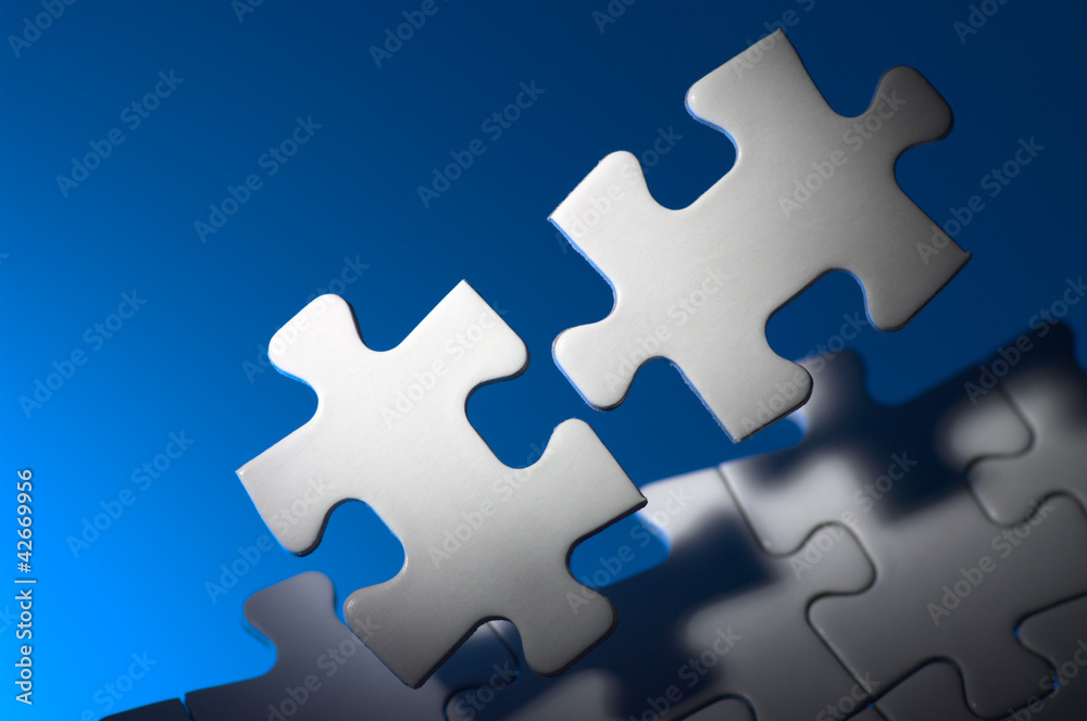 Fitting puzzle pieces in spot light. Fitting puzzle pieces in spot light.