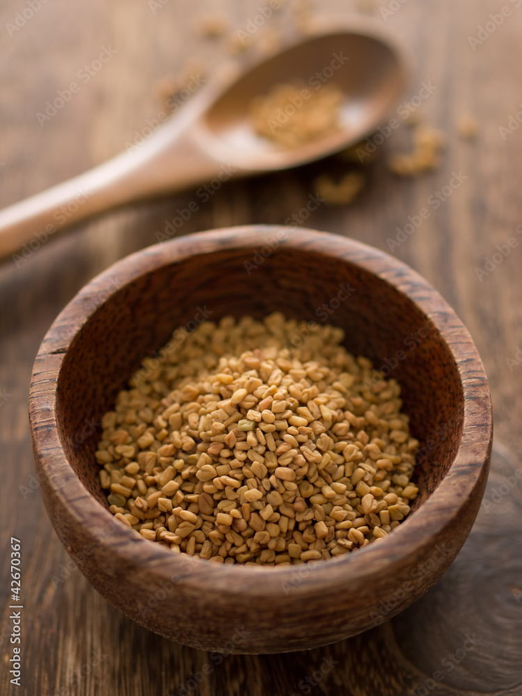 close up of a bowl of fenugreek seeds close up of a bowl of fenugreek seeds