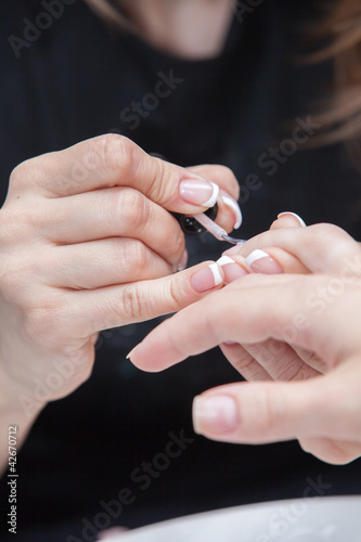 Nail polishing during manicure in the salon