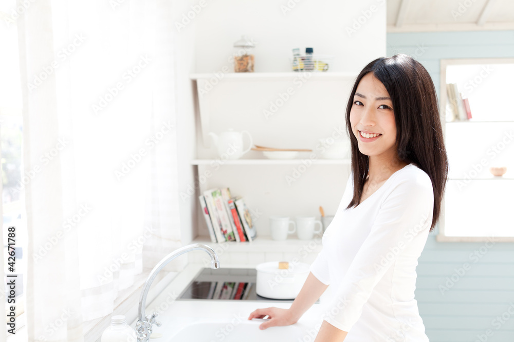 a young asian woman in the kitchen a young asian woman in the kitchen