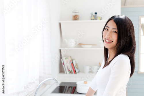 a young asian woman in the kitchen