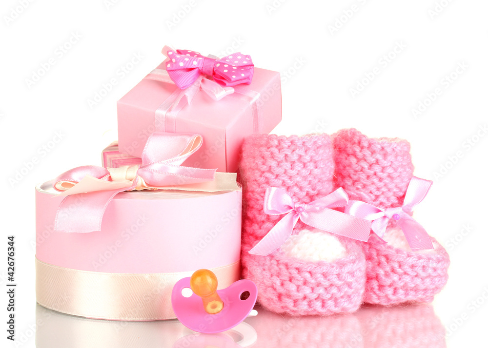 pink baby boots, pacifier and gifts isolated on white pink baby boots, pacifier and gifts isolated on white