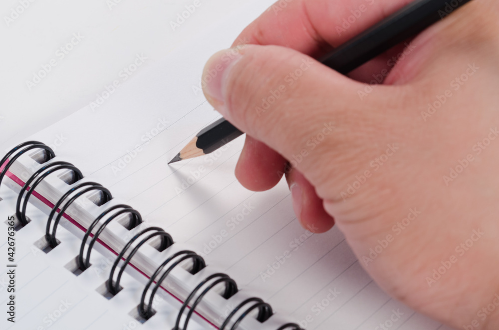 Handwriting with pencil in open notebook Handwriting with pencil in open notebook