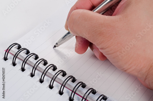 Hand writing in open notebook