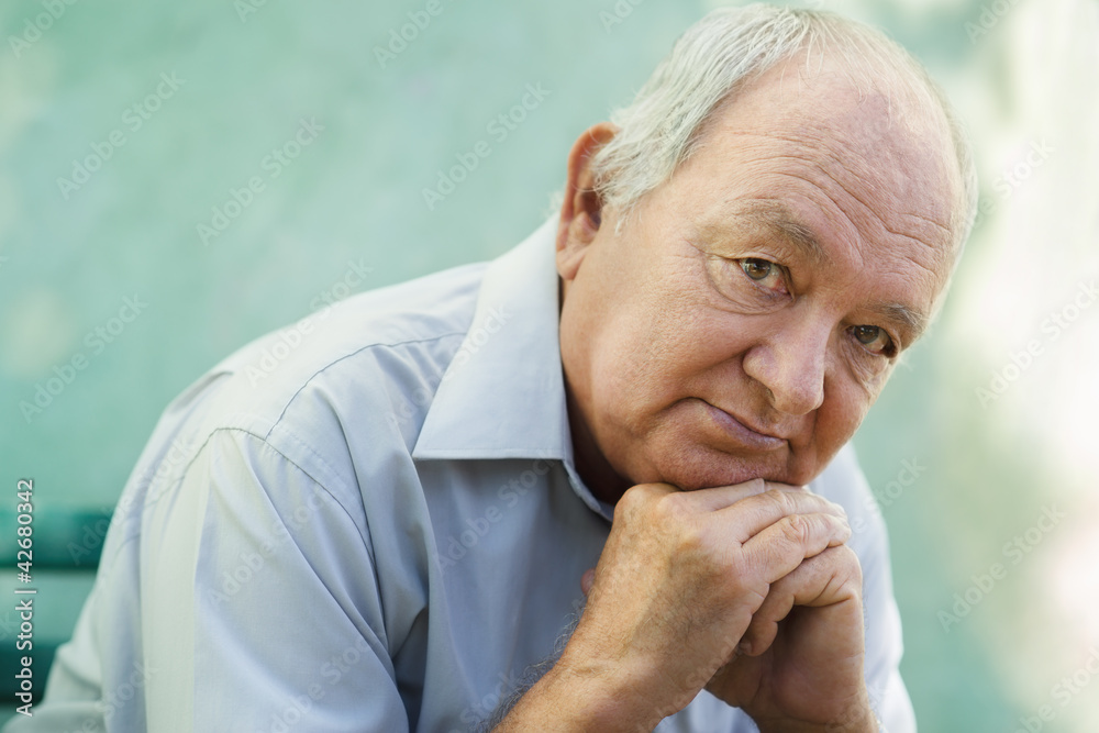 Portrait of sad bald senior man looking at camera Portrait of sad bald senior man looking at camera