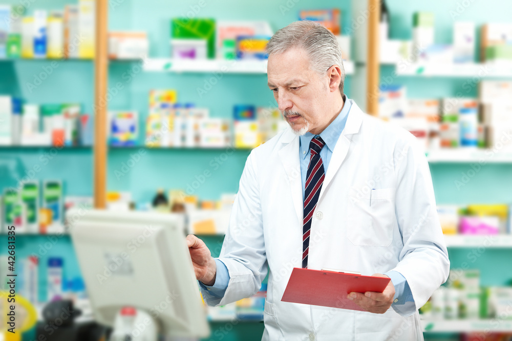 Pharmacist looking at the computer