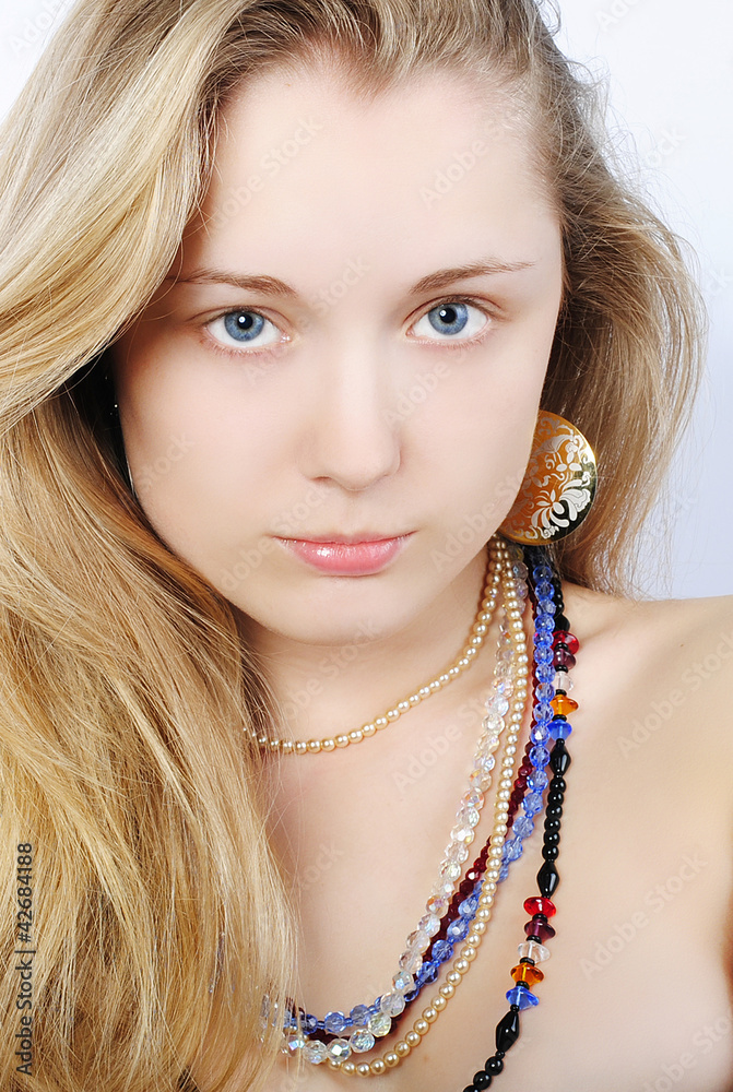 Portrait of the beautiful girl in costume jewellery