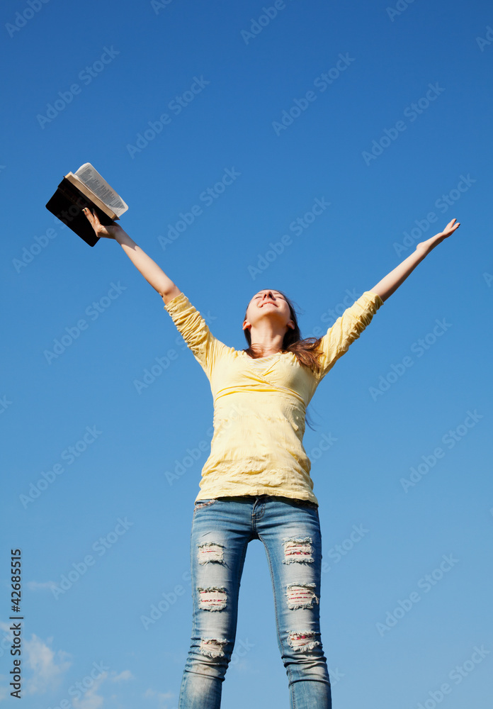 Young woman staying with raised hands