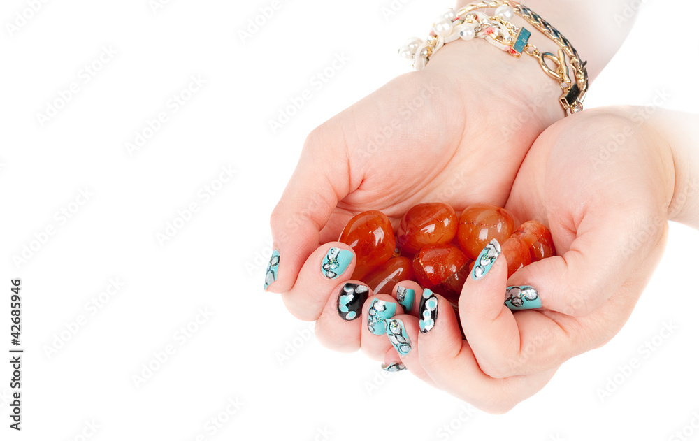 Female hands and blue modern manicure and orange geam minirals. Female hands and blue modern manicure and orange geam minirals.