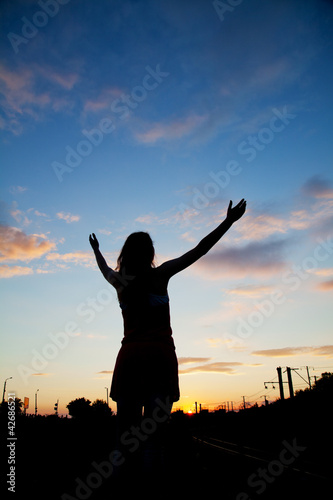 Woman staying with raised hands