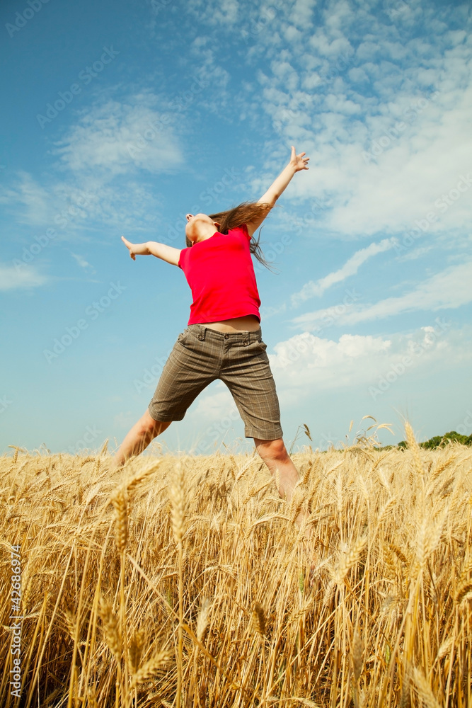Teen girl jumping at a wheat field Teen girl jumping at a wheat field