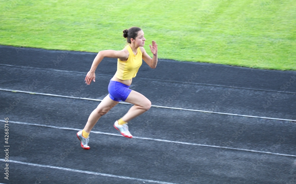Girl running on the track Girl running on the track