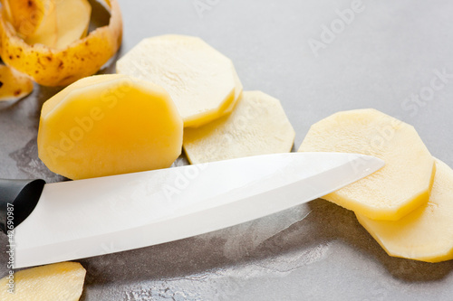 Ceramic knife and raw potatoes