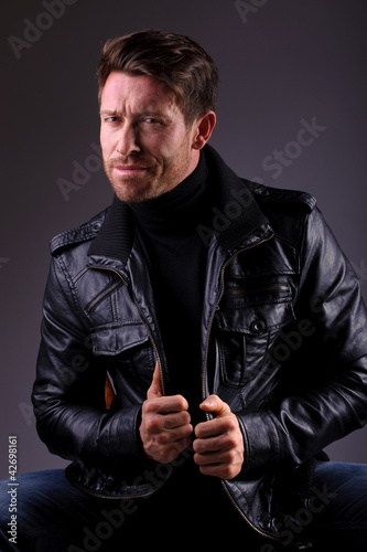 handsome man in leather jacket seated