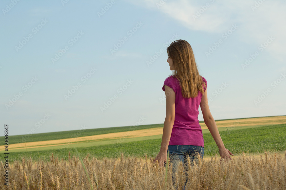 Young girl walking in the field Young girl walking in the field