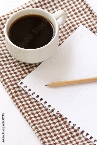 White cup coffee with notepad and pencil