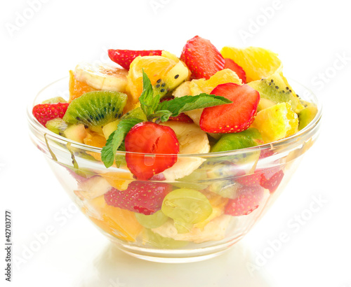 glass bowl with fresh fruits salad isolated on white