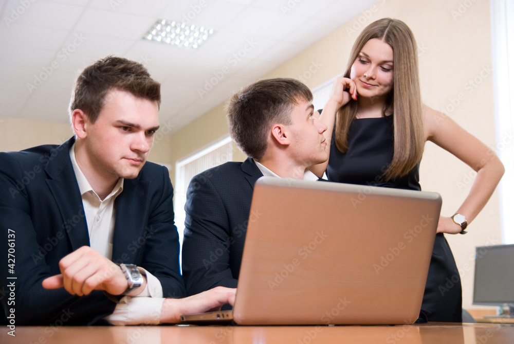 Business group behind the laptop Business group behind the laptop