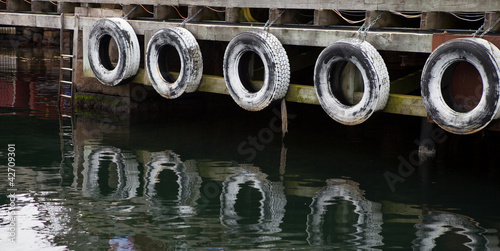 Row of old tires to protect boats © Christian Morales