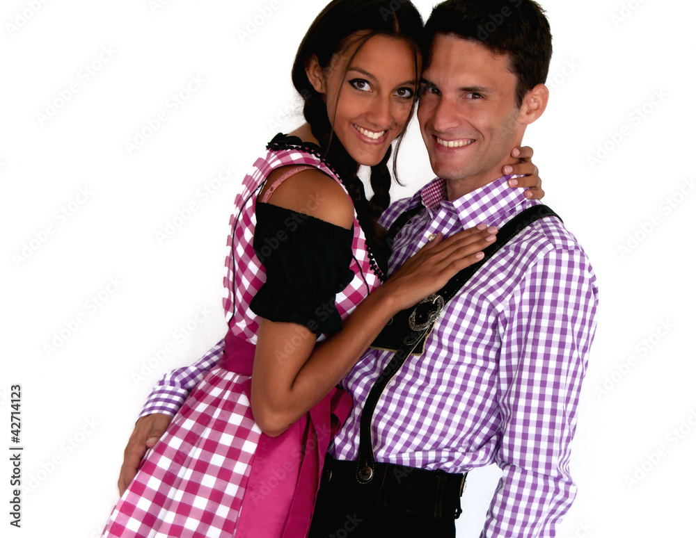 Fröhliches Bayerisches Paar mit Lederhosen und Dirndl Fröhliches Bayerisches Paar mit Lederhosen und Dirndl