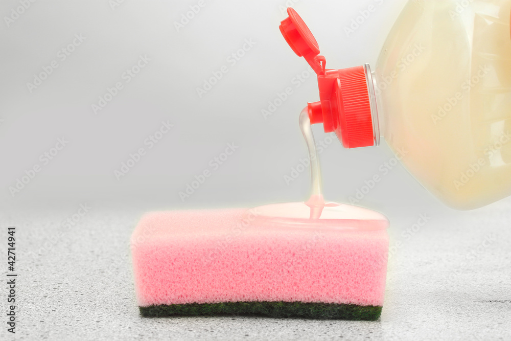 bright sponge with dish washing liquid on marble background bright sponge with dish washing liquid on marble background