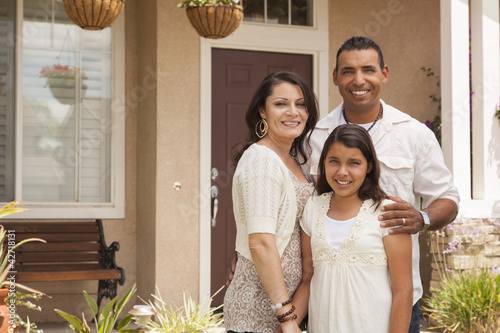 Small Hispanic Family in Front of Their Home photo
