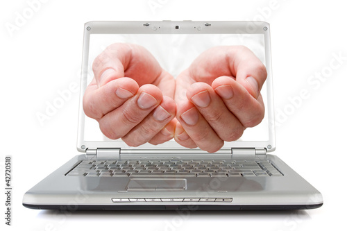 open palms coming out of a laptop