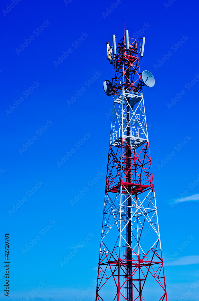 Telecommunications tower, painted white and red in a day of clea Telecommunications tower, painted white and red in a day of clea