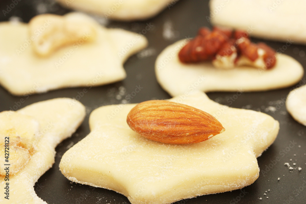 unbaked cookies with candied fruits and nuts in a pan close-up unbaked cookies with candied fruits and nuts in a pan close-up