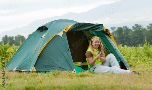 Camping happy woman front of tent