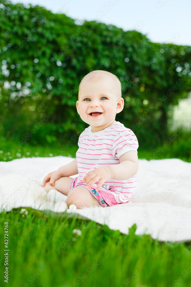 baby girl in dress sitting on green grass outdoors baby girl in dress sitting on green grass outdoors