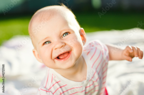 baby smiling and looking in camera