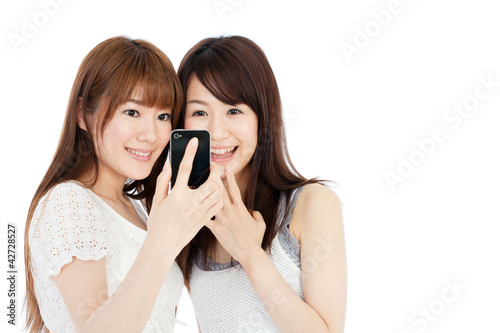 Beautiful young women using a mobile phone. Portrait of asian.