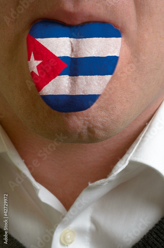 man tongue painted in cuba flag symbolizing to knowledge to spea