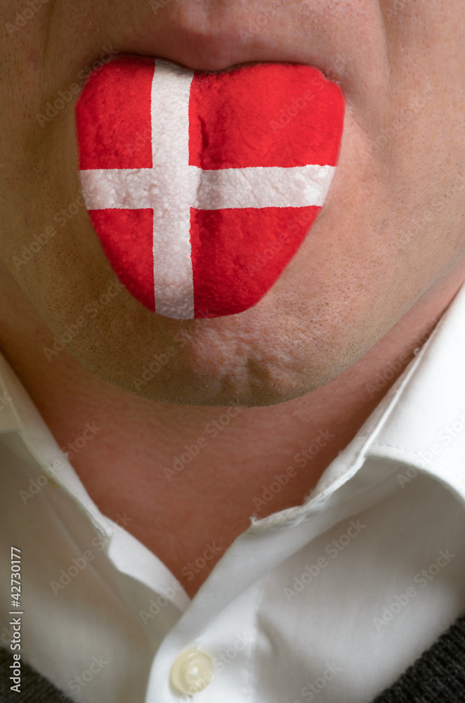 Fototapeta premium man tongue painted in denmark flag symbolizing to knowledge to s
