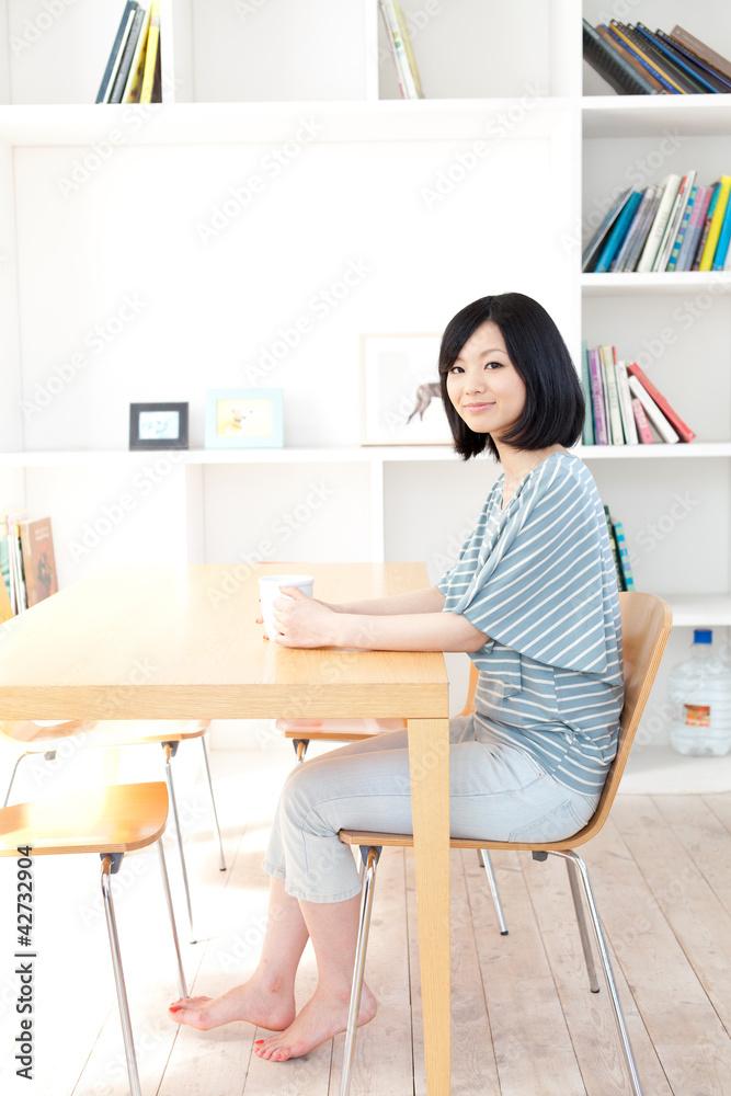 a young asian woman relaxing in the room a young asian woman relaxing in the room