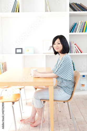 a young asian woman relaxing in the room