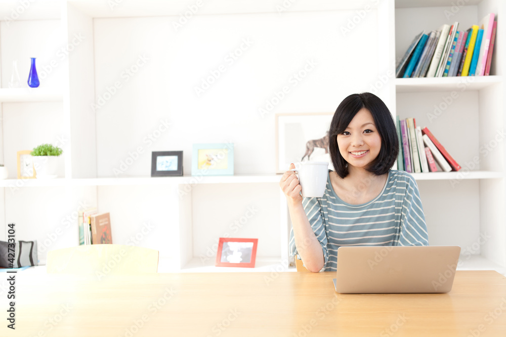 a young asian woman using laptop computer