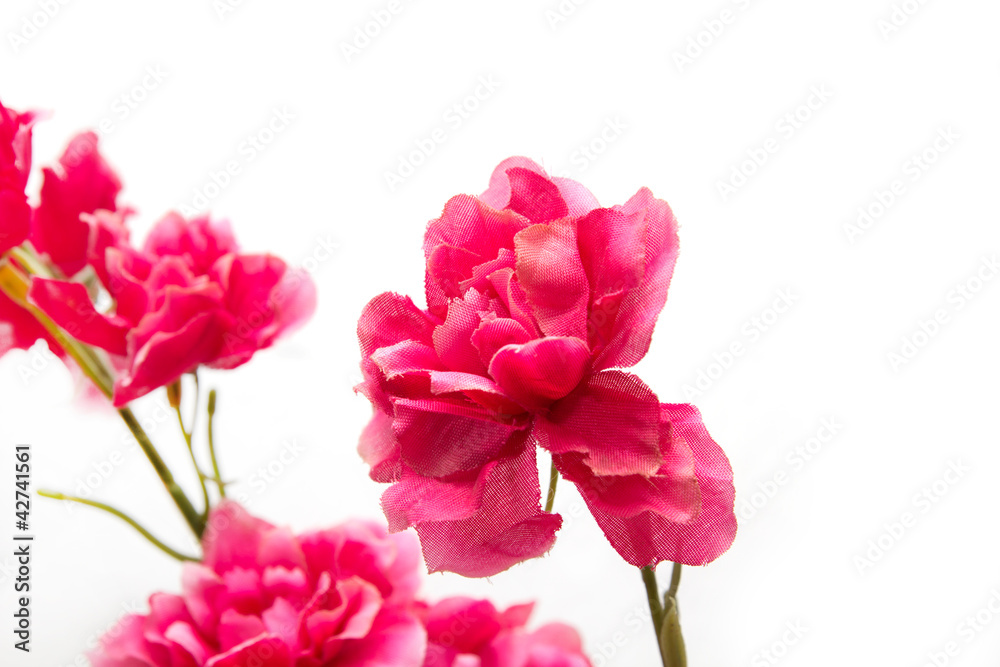 Artificial red flowers on a white background