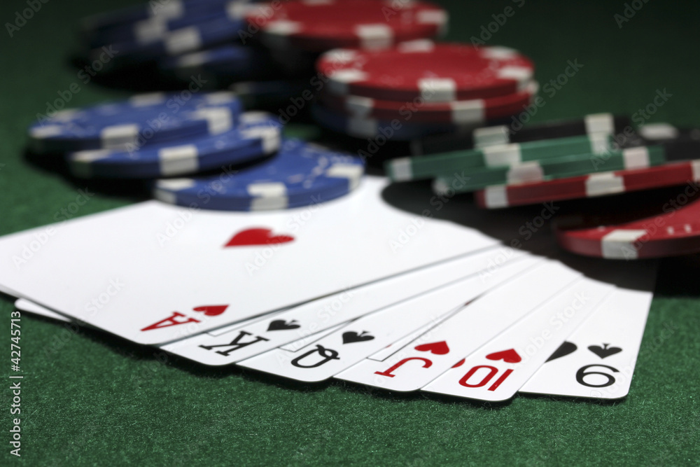 Cards and chips for poker on green table Cards and chips for poker on green table