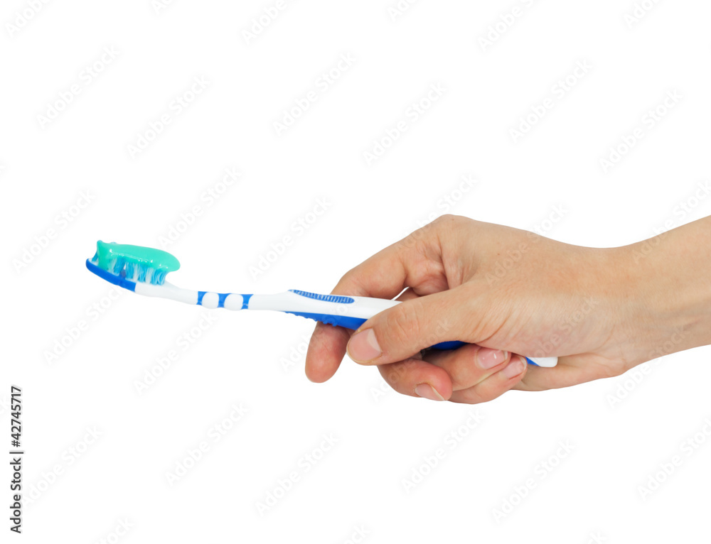 Toothbrush and toothpaste in a hand Toothbrush and toothpaste in a hand