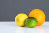 Beautiful citrus fruits in front of grey
