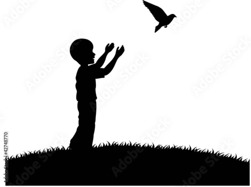 Little boy releasing a white pigeon